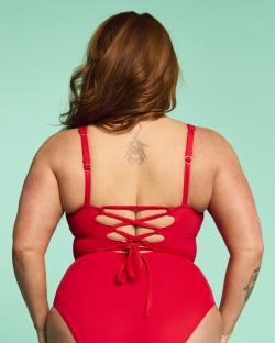 Woman in red swimsuit, back view.