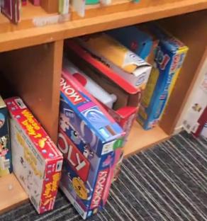 Board games on a shelf.