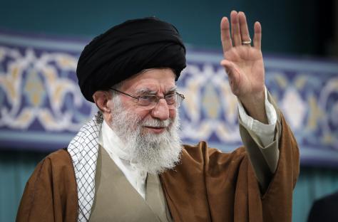 Ayatollah Ali Khamenei waving to a crowd.