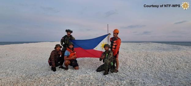 Brazen China plants flag on seized TINY 2,000sq ft sandbank in WW3 flashpoint sea…before Philippines’ tit-for-tat reply
