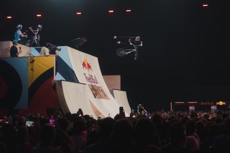 BMX rider performing a trick at a Red Bull event.