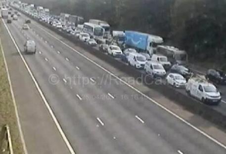 M1 closed in both directions after crash near central reservation – with queues for miles during rush hour