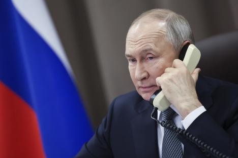 Vladimir Putin on the phone during a Christmas charity campaign.