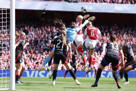 Christiane Endler of Lyon and Leah Williamson of Arsenal vying for the ball during a UEFA Women's Champions League match.