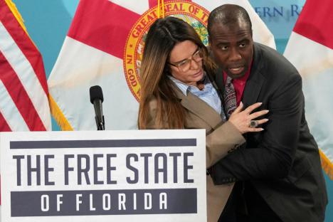 Dramatic moment doctor leaps onto stage to save politician as she suddenly faints mid-speech