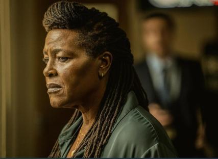 Still from the TV show *Ellis*, featuring a woman with long dreadlocks.