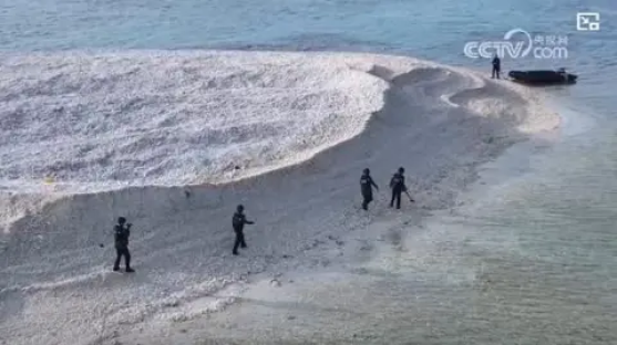 Aerial view of people on a small sandbar in the South China Sea.