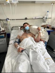 A groom-to-be in a hospital bed with his fiancée.