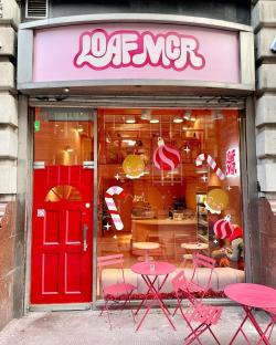Exterior view of Loaf MCR bakery with Christmas decorations in the window.