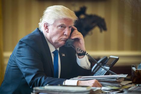 President Donald Trump on the phone in the Oval Office.