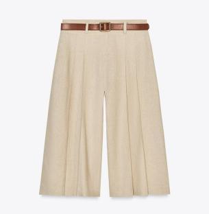 Beige linen culottes with a brown belt.