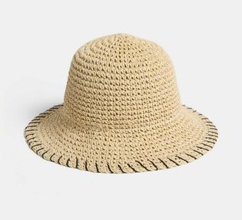 Beige crochet bucket hat with black stitching.